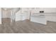 Open-concept kitchen with white cabinets, large island, and stainless steel appliances at 534 Nolden Trl, Dacula, GA 30019
