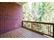Private wooden balcony with metal railing overlooking mature trees at 1096 Holly Ave, Atlanta, GA 30338