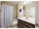Full bathroom with tiled shower over tub, single sink vanity, and neutral decor at 1096 Holly Ave, Atlanta, GA 30338