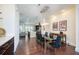 Elegant dining room with modern chandelier and hardwood floors open to kitchen at 1096 Holly Ave, Atlanta, GA 30338