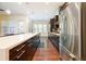 Open concept kitchen with stainless steel appliances and large island with breakfast bar at 1096 Holly Ave, Atlanta, GA 30338