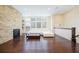 Cozy living room with stone accent wall, fireplace, hardwood floors, and ample natural light at 1096 Holly Ave, Atlanta, GA 30338