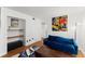 Cozy living room with a blue sofa, modern art, and open shelving at 1355 Euclid Ne Ave # 21B, Atlanta, GA 30307