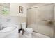 Clean bathroom featuring tile flooring, a frosted glass shower door, and white tiled walls at 3474 Castleridge Dr, Tucker, GA 30084