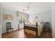 Cozy bedroom featuring a ceiling fan, a window, and hardwood floors at 3474 Castleridge Dr, Tucker, GA 30084