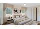 Staged bedroom features hardwood floors, two large windows, closet, and neutral decor at 3474 Castleridge Dr, Tucker, GA 30084