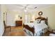 Comfortable bedroom featuring hardwood floors, a decorative wreath, and a ceiling fan at 3474 Castleridge Dr, Tucker, GA 30084
