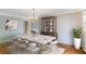 Dining room virtually staged with modern furniture, a hutch, and an area rug at 3474 Castleridge Dr, Tucker, GA 30084