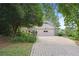 Long driveway leading to a two-car garage, surrounded by mature trees and beautiful landscaping at 3474 Castleridge Dr, Tucker, GA 30084