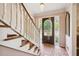 Inviting foyer with brick flooring, a decorative front door, staircase and chandelier at 3474 Castleridge Dr, Tucker, GA 30084