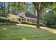 Beautiful home with a well-manicured front yard, green lawn, mature trees, and an inviting facade at 3474 Castleridge Dr, Tucker, GA 30084