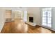 Living room with a fireplace, built-in shelving and cabinets, and hardwood floors at 3474 Castleridge Dr, Tucker, GA 30084