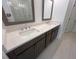 A primary bathroom features dual sinks with framed mirrors, quartz countertops and tile flooring at 634 Skytop Dr # 155, Cumming, GA 30040