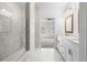 A clean bathroom with double vanities and a glass shower, leading to a well-lit bedroom at 634 Skytop Dr # 155, Cumming, GA 30040