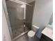 Modern bathroom features gray tile in shower and glass doors at 634 Skytop Dr # 155, Cumming, GA 30040
