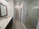 A modern bathroom features a spacious shower with glass door and a vanity with dark wood cabinets at 634 Skytop Dr # 155, Cumming, GA 30040