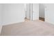 Spacious bedroom with neutral carpet, and doors leading to the bathroom and hallway at 634 Skytop Dr # 155, Cumming, GA 30040