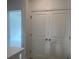 A view of double closet doors in a home with an adjacent doorway leading to a bedroom at 634 Skytop Dr # 155, Cumming, GA 30040