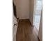 Hallway with wood floors leading to a bright, adjacent room at 634 Skytop Dr # 155, Cumming, GA 30040