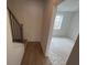 Hallway with wood floors and a stair case leading to a bright, adjacent room at 634 Skytop Dr # 155, Cumming, GA 30040