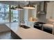 A kitchen featuring a large island, pendant lighting, stainless steel appliances, and a window view at 634 Skytop Dr # 155, Cumming, GA 30040