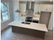 A kitchen boasts modern pendant lighting, an island with a sink, and stainless steel appliances at 634 Skytop Dr # 155, Cumming, GA 30040
