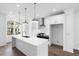 Kitchen features a large island, modern appliances, white cabinetry, recessed lights, and hardwood floors at 634 Skytop Dr # 155, Cumming, GA 30040