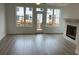 The living room has windows and a door, a fireplace, and hardwood floors at 634 Skytop Dr # 155, Cumming, GA 30040