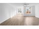 Bright living room features hardwood floors, recessed lighting, and large windows at 634 Skytop Dr # 155, Cumming, GA 30040