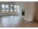 The living room has windows and a door, a fireplace, and hardwood floors at 634 Skytop Dr # 155, Cumming, GA 30040