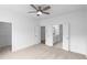 Spacious main bedroom features plush carpet, ensuite bathroom, walk-in closet, and a ceiling fan at 634 Skytop Dr # 155, Cumming, GA 30040