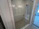 A modern shower features a seamless glass enclosure, built-in bench and sleek fixtures at 634 Skytop Dr # 155, Cumming, GA 30040