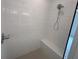 A beautifully tiled shower includes a built-in bench and modern shower head at 634 Skytop Dr # 155, Cumming, GA 30040
