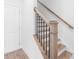 Modern staircase featuring wood steps, black metal balusters, and white risers at 634 Skytop Dr # 155, Cumming, GA 30040
