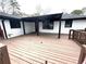 Expansive wooden back deck features access to the house with exterior fan details at 2267 Bryant Dr, East Point, GA 30344