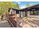 Expansive wooden back deck features wheelchair ramp and access to the house with exterior fan details at 2267 Bryant Dr, East Point, GA 30344