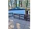 Wood deck of home features a deck railing surrounding detached garage in background at 2267 Bryant Dr, East Point, GA 30344