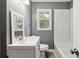 Modern bathroom featuring a new vanity, window, and tiled shower/tub at 2267 Bryant Dr, East Point, GA 30344
