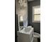 Updated bathroom with modern vanity, mirror and new light fixture at 2267 Bryant Dr, East Point, GA 30344