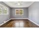 Clean bedroom with hardwood floors, gray walls, and two windows providing natural light at 2267 Bryant Dr, East Point, GA 30344