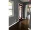 Entryway with hardwood floors, new red front door and gray paint at 2267 Bryant Dr, East Point, GA 30344