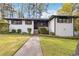 Charming white brick home with landscaped front yard and a stone walkway leading to the entrance at 2267 Bryant Dr, East Point, GA 30344