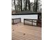 Wood deck of home features a deck railing surrounding detached garage in background at 2267 Bryant Dr, East Point, GA 30344