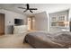 Bedroom features a large window, ceiling fan, and mirrored dresser at 3720 River Mansion Dr, Peachtree Corners, GA 30096