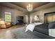 Spacious bedroom featuring a tray ceiling, hardwood floors, and large windows at 3720 River Mansion Dr, Peachtree Corners, GA 30096