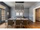 Sophisticated dining room featuring modern lighting, gray walls, and beautiful hardwood floors at 3720 River Mansion Dr, Peachtree Corners, GA 30096