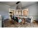 Stylish dining room with contemporary chandelier, ample seating, and views into other living spaces at 3720 River Mansion Dr, Peachtree Corners, GA 30096