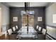 Elegant dining room with modern chandelier, statement walls, and view to the outdoors at 3720 River Mansion Dr, Peachtree Corners, GA 30096