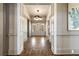 Grand foyer with herringbone wood floors, decorative molding, and an elegant chandelier at 3720 River Mansion Dr, Peachtree Corners, GA 30096