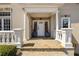 Charming covered front porch with stone tile, stately columns, and a welcoming entrance at 3720 River Mansion Dr, Peachtree Corners, GA 30096